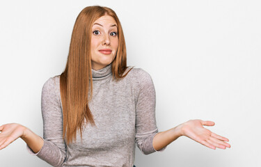 Young irish woman wearing casual clothes clueless and confused expression with arms and hands...