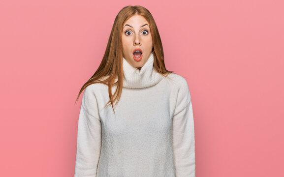 Young irish woman wearing casual winter sweater afraid and shocked with surprise and amazed expression, fear and excited face.