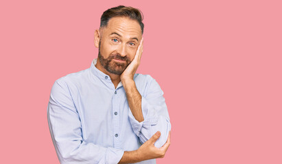 Handsome middle age man wearing business shirt thinking looking tired and bored with depression problems with crossed arms.