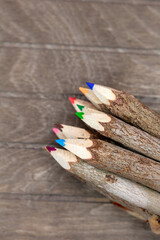 crayons bounded of untreated wood, unique and with real tree bark on wooden a board for artists, nature lovers and students
