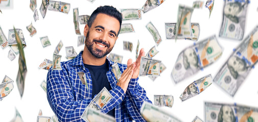 Young hispanic man wearing casual clothes clapping and applauding happy and joyful, smiling proud hands together