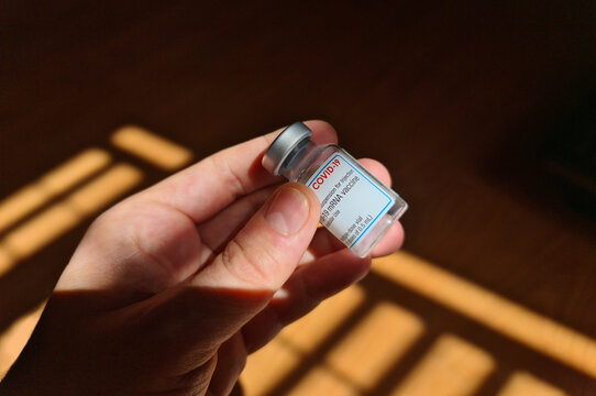 Vial of covid vaccine held in hand