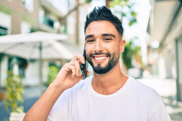 Young arab man with serious expression talking on the smartphone at the city.