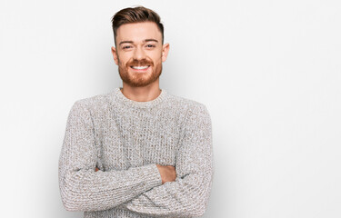 Young redhead man wearing casual winter sweater happy face smiling with crossed arms looking at the...