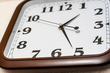 Closeup view of Analog Clock on the Wall with Brown Frame