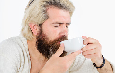 Good morning. Bearded man with cup of coffee. Handsome male enjoying mug of drink.