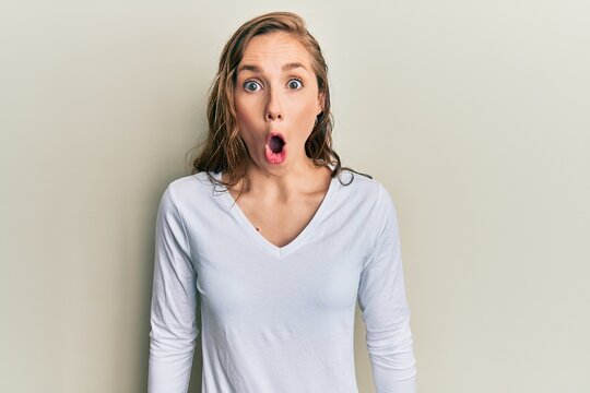 Young blonde woman wearing casual clothes afraid and shocked with surprise expression, fear and excited face.