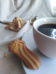 a cup of coffee cookies pearl and shell