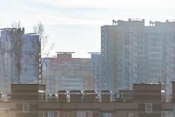 Fototapeta premium High-rise buildings under the bright sun. New areas of Moscow are growing up. Houses against a bright sky.