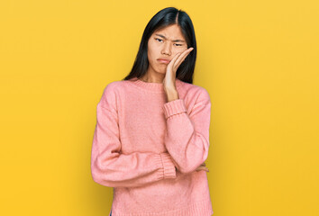 Beautiful young asian woman wearing casual winter sweater thinking looking tired and bored with depression problems with crossed arms.