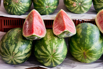 Selection of organic watermelons on display at the market stall. Acendría or Síndria. Water melon, scientific name Citrillus Lanatus.