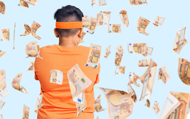 Little boy kid wearing sportswear standing backwards looking away with crossed arms