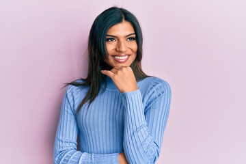 Fototapeta premium Young latin transsexual transgender woman wearing casual clothes with hand on chin thinking about question, pensive expression. smiling with thoughtful face. doubt concept.