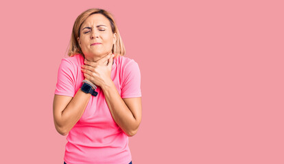 Young blonde woman wearing sportswear shouting suffocate because painful strangle. health problem. asphyxiate and suicide concept.