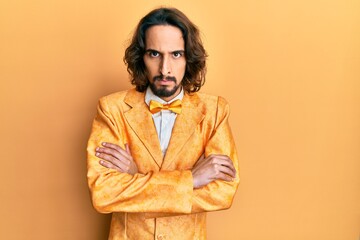 Young hispanic man wearing hipster elegant look skeptic and nervous, disapproving expression on face with crossed arms. negative person.