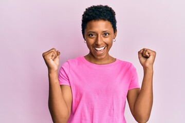 Young african american girl wearing casual clothes screaming proud, celebrating victory and success very excited with raised arms