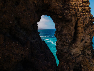 Fototapeta premium hole in the rock silhouette of a girl