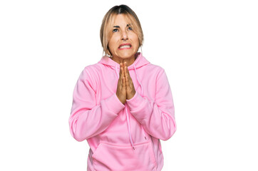Young caucasian woman wearing casual sweatshirt begging and praying with hands together with hope...