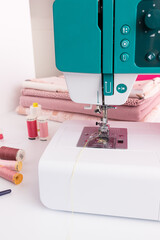 White and green sewing machine ready to work.