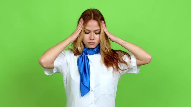Young blonde teenager girl with stewardess uniform unhappy and frustrated with something over isolated background. Green screen chroma key