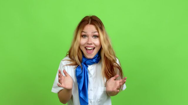 Young blonde teenager girl with stewardess uniform with surprise and shocked facial expression over isolated background. Green screen chroma key