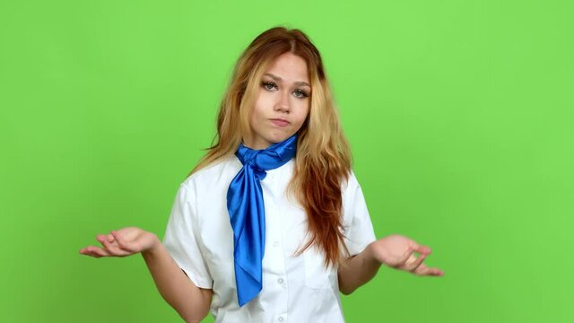 Young blonde teenager girl with stewardess uniform having doubts over isolated background. Green screen chroma key