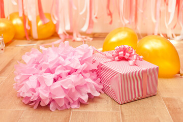Gift box on pink and golden Birthday decorations
