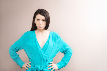Obraz premium Stylish woman in summer dress making poses against the plain empty pastel wall. Studio shot. Copy space for text, beauty, fashion ad concept