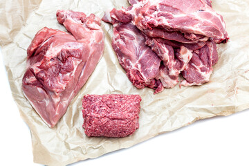 Pork pieces, forcemeat and fillet on white background close-up