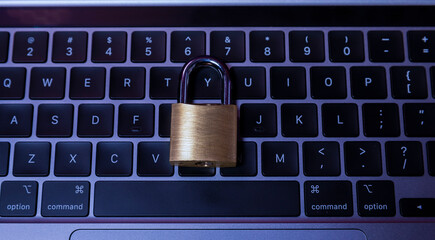 Padlock in keyboard illustrating online security concept