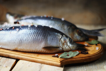 Selective focus. Spicy salted herring. Whole salted herring. Norwegian herring. Saltwater fish omega 3.