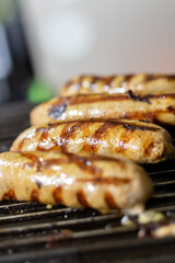 grilled pork sausages lie in a row on the grill selective focus