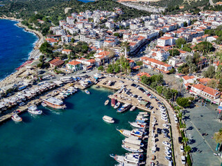 The top view from the drone of Kas resorts and city with amazing blue and clear lagoon and yachts in Mugla province of Turkey