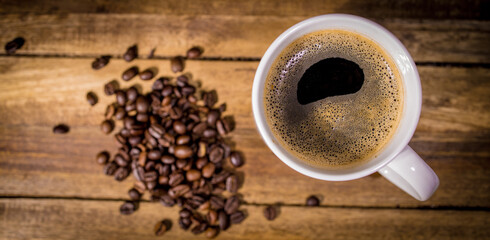 Freshly brewed cup of coffee on a wooden table - studio photography
