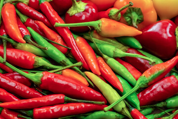 assorted chili peppers red green bright pods seasoning background