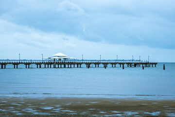 Fototapeta premium Shorncliffe Pier with cloudy sky. The jetty is scene from the beach.