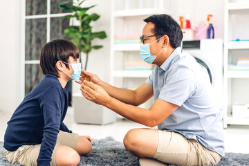 Portrait of enjoy happy love asian father wearing protective mask for little asian boy child in quarantine for coronavirus with social distancing at home.covid19 concept
