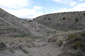 Dry mountainous travel destination with distant information panels