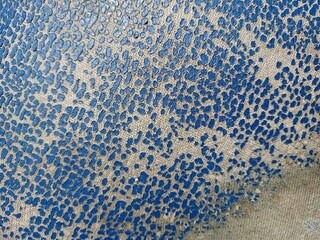 Old leather texture. Dotted blue texture on the fabric.