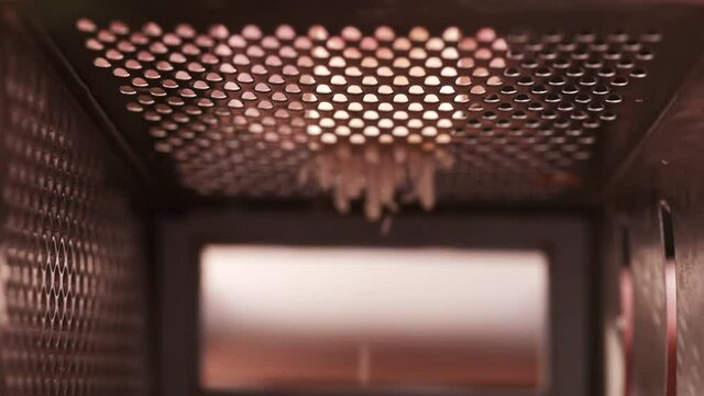 View Inside The Grater. Inside The Kitchenware. Macro Video Of Cheese On Grater.