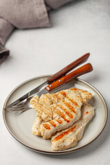The turkey fillet is grilled in a plate on the table. Healthy diet