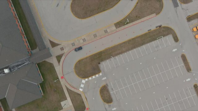 Aerial top view the group of yellow school buses parked near the high school