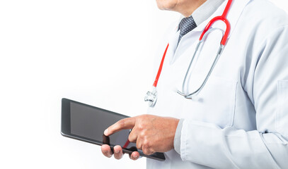 Medium shot of a doctor in a gown and tie whose face is not recognizable with a stethoscope and a tablet. Medicine and technology concept