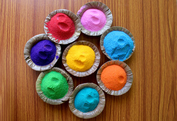 Indian Holi  traditional colors in disposal organic bowl, different organic Gulal color on the occasion of Holi festival, Abstract background, selective focus with blur.
