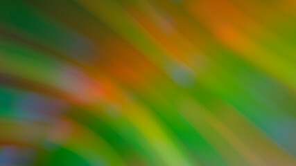 Abstract blurry green background with rainbow highlights