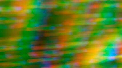 Abstract blurry green background with rainbow highlights