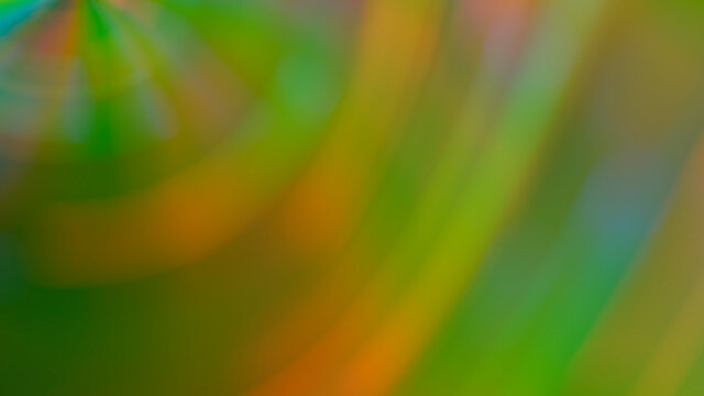 Abstract blurry green background with rainbow highlights