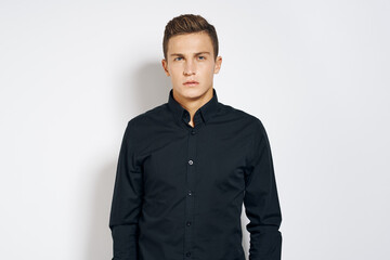 Elegant man in black shirt attractive look cropped view light background