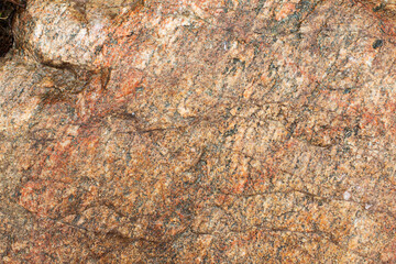 texture of red granite stone for background. wet stone surface from rain.