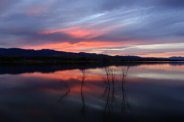 Fototapeta na wymiar Sun setting over a calm lake in Nevada's desert